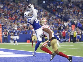 Indianapolis Colts tight end Eric Ebron (85) makes a catch in the end zone over San Francisco 49ers cornerback Ahkello Witherspoon (23) for a touchdown in the first half of an NFL preseason football game in Indianapolis, Saturday, Aug. 25, 2018.