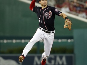 Washington Nationals shortstop Trea Turner jumps to throw out Miami Marlins' J.T. Realmuto during the first inning of a baseball game at Nationals Park, Friday, Aug. 17, 2018, in Washington.