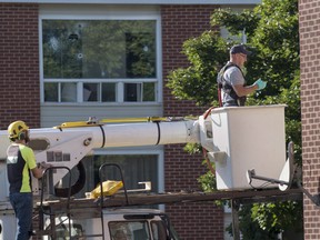 An RCMP forensic investigator prepares to examine a building adjacent to where Matthew Vincent Raymond is alleged to have gone on a shooting spree in Fredericton on Saturday, August 11, 2018. Two city police officers were among four people who died in a shooting in a residential area on the city's north side.
