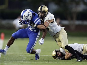 Duke's Brittain Brown (22) is forced out of bounds by Army's Max Regan during the first half of an NCAA college football game in Durham, N.C., Friday, Aug. 31, 2018.