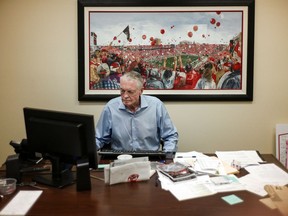 In this July 31, 2018, photo, former Nebraska coach Tom Osborne works in his office in Lincoln, Neb. Current Nebraska NCAA college football head coach Scott Frost has said repeatedly that Nebraska made a mistake moving away from the methods Osborne successfully used. Frost's job is to return his team to the place it held in the college football hierarchy two decades ago by returning to the methods Osborne used on and off the field to make the Cornhuskers great.