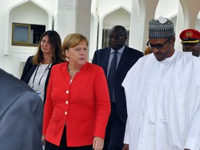 German Chancellor Angela Merkel, left, is welcomed by Nigeria's President Muhammadu Buhari, at the Presidential palace in Abuja, Nigeria, Friday, Aug 31, 2018. Merkel is wrapping up a three-day Africa visit in Nigeria with a meeting between the leaders of Europe's and Africa's largest economies that is likely to focus on migration.