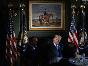President Donald Trump listens during a meeting with state leaders about prison reform, Thursday, Aug. 9, 2018, at Trump National Golf Club in Bedminster, N.J.