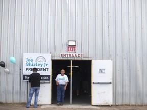 Nathaniel Yazzie of Saint Michaels, Ariz., and a member of Joe Shirley Jr.'s campaign committee walks out of Shirley's campaign headquarters, in Window Rock, Ariz., Tuesday, Aug. 28, 2018. Shirley is the former Navajo Nation president and a current nominee. Voters on the country's largest American Indian reservation are headed to the polls to narrow a record field of 18 candidates for Navajo Nation president.