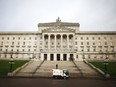 In this Monday, Jan. 16, 2017 file photo, a road sweeper van passes Stormont, Belfast, Northern Ireland. Protesters in Northern Ireland are demanding feuding political parties get back to governing, as the region matches a record for the world's longest peacetime period without a government.