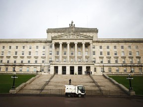 In this Monday, Jan. 16, 2017 file photo, a road sweeper van passes Stormont, Belfast, Northern Ireland. Protesters in Northern Ireland are demanding feuding political parties get back to governing, as the region matches a record for the world's longest peacetime period without a government.