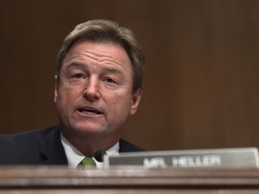 FILE - In this Jan. 30, 2018, file photo, Sen. Dean Heller, R-Nev., asks a question during a Senate Banking Committee hearing on Capitol Hill in Washington. Heller, considered the most vulnerable GOP senator seeking another term this year, opposed measures to dismantle President Barack Obama's signature law before backing other versions that failed.