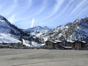 FILE - This Dec. 16, 2013 file photo, shows the expansive parking lot at the base village at Squaw Valley in Olympic Valley, Calif. Environmentalists have lost their latest legal bid to block a major redevelopment project at a Lake Tahoe-area ski resort that hosted the 1960 Winter Olympics. Placer County Superior Court Judge Michael W. Jones on Aug. 13, 2018, rejected Sierra Watch's claims that the expansion of the Village at Squaw Valley would violate the California Environmental Quality Act.