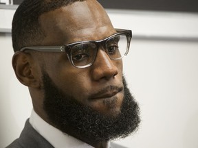 FILE - In this July 30, 2018 file photo LeBron James listens to a question at a news conference after the opening ceremony for the I Promise School in Akron, Ohio. President Donald Trump is turning his wrath on the basketball superstar.  Trump tweeted late Friday, Aug. 3 that James was interviewed "by the dumbest man on television," CNN anchor Don Lemon, but that he "made Lebron look smart, which isn't easy to do."