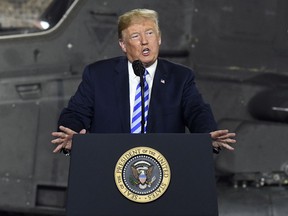 FILE - In this Aug. 13, 2018 file photo, President Donald Trump speaks before signing a $716 billion defense policy bill named for Sen. John McCain  in Fort Drum, N.Y.  Trump says he's asking federal regulators to look into the effectiveness of the quarterly financial reports that publicly traded companies are required to file.  In a tweet early Friday, Aug. 17, Trump said that after speaking with "some of the world's top business leaders," he's asked the U.S. Securities and Exchange Commission to determine whether shifting to a six-month reporting regimen would make more sense.