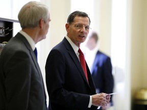 FILE - In this March 20, 2018, file photo, Sen. John Barrasso, R-Wyo., right speaks with Sen. Rob Portman, R-Ohio, after a Republican policy luncheon on Capitol Hill in Washington. On Tuesday, Aug. 21, 2018, Barrasso fended off a well-funded challenger in Wyoming's Republican primary and will face Wilson businessman Gary Trauner in the general election. Trauner ran unopposed for the Democratic nomination.