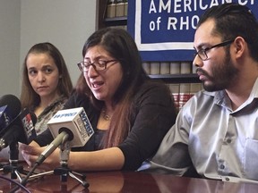 FILE - In this Feb. 14, 2018, file photo, Lilian Calderon, center, cries as she describes her experiences while in custody, alongside her husband, Luis Gordillo, right, during a news conference at the office of the American Civil Liberties Union in Providence, R.I.   Gordillo is a U.S. citizen, but Calderon is a native of Guatemala who came to the country with her family at the age of 3. She was ordered to leave in 2002 after her father was denied asylum.