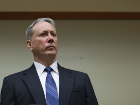 FILE- In this June 6, 2016 file photo, former DeKalb Police Officer Robert Olsen stands during his arraignment in Decatur, Ga.  A judge has ruled that the former Atlanta-area police officer who fatally shot an unarmed, naked, mentally ill black veteran isn't entitled to immunity based on self-defense. Lawyers for  Olsen had argued he had the right to act in self-defense and that the charges against him should be dropped. Olsen faces charges including felony murder in the March 2015 death of 27-year-old Anthony Hill, whose family has said he was a U.S. Air Force veteran who struggled with mental health problems.