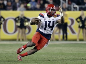 FILE - In this Dec. 27, 2017, file photo, Arizona quarterback Khalil Tate runs against Purdue during the second half of the Foster Farms Bowl NCAA college football game in Santa Clara, Calif. As a versatile quarterback who can beat defenses with his arm and legs, Tate fits the profile of many other recent Heisman winners.