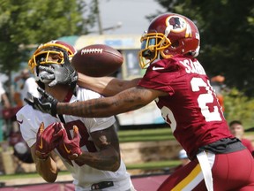 File-This July 26, 2018, file photo shows Washington Redskins cornerback Orlando Scandrick, right, breaking up a pass intended for wide receiver Josh Doctson at NFL football training camp in Richmond, Va. The Washington Redskins have released Scandrick. Coach Jay Gruden confirmed the move Tuesday, Aug. 14, 2018, before the final practice of training camp. Washington signed Scandrick to a two-year deal in March after the Dallas Cowboys cut him. Gruden says the decision had nothing to do with Scandrick's play.