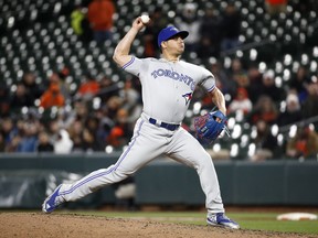 FILE - In this April 10, 2018, file photo, Toronto Blue Jays relief pitcher Roberto Osuna throws to a Baltimore Orioles batter during a baseball game in Baltimore. Houston Astros manager A.J. Hinch has met privately with the team's owner and general manager ahead of Osuna being activated following a 75-game suspension for violating Major League Baseball's domestic violence policy. Hinch says Osuna will join the Astros in Los Angeles on Sunday, Aug. 5, and be activated for the series finale against the Dodgers. The Astros acquired the right-handed reliever from the Blue Jays at the trade deadline this week.