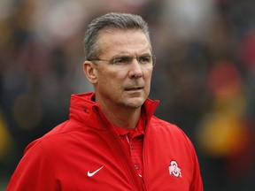 FILE - In this Nov. 4, 2017, file photo, Ohio State head coach Urban Meyer walks on the field before an NCAA college football game against Iowa, in Iowa City, Iowa. Ohio State trustees are set to discuss the future of football coach Urban Meyer. The 20-member board plans to meet in private on Wednesday morning, Aug. 22, 2018, in Columbus to decide whether Meyer should be punished for his handling of domestic-abuse allegations against a former assistant coach.