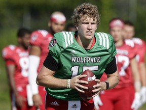 FILE - In this Aug. 9, 2018, file photo, North Carolina State quarterback Ryan Finley runs through a drill during an NCAA college football practice in Raleigh, N.C. Finley returned to school for his final season after flirting with entering the NFL draft and opens the year Saturday against James Madison.