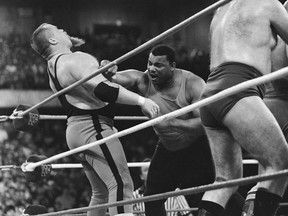 File-This April 7, 1986, file photo shows Chicago Bears' William Perry, right, landing a punch on pro wrestler Jim "The Anvil" Neidhart during the "Over-The-Top-Rope" battle royal at Wrestlemania 2 in Rosemont, Ill. Neidhart, who joined with Bret Hart to form one of the top tag teams in the 1980s with the WWE, has died. He was 63. The Pasco Sheriff's Office said Neidhart fell at home, hit his head and "succumbed to his injury" on Monday, Aug. 13, 2018, in Wesley Chapel, Fla. No foul play was suspected.