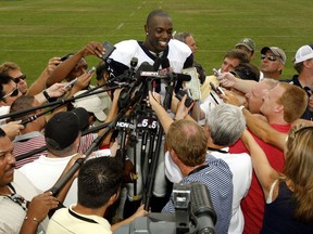 In this July 29, 2006, file photo, Dallas Cowboys wide receiver Terrell Owens talks with the media after football practice on the first day of training camp in Oxnard, Calif. Owens is skipping his induction ceremony into the Pro Football Hall of Fame in Canton, Ohio on Saturday, Aug. 4, 2018, and instead giving his acceptance speech at the University of Tennessee at Chattanooga.