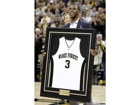 FILE - In this March 2, 2013, file photo, Los Angeles Clippers' Chris Paul shows his Wake Forest jersey to fans as the school retired his number during a ceremony at halftime of an NCAA college basketball game between Wake Forest and Maryland in Winston-Salem, N.C. Former Wake Forest guard and NBA All-Star Chris Paul is donating $2.5 million in support of the Demon Deacons' basketball team, the school announced Tuesday, Aug. 7, 2018.