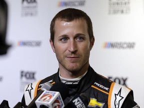 FILE - In this Feb. 14, 2018, file photo, Kasey Kahne speaks during media day for the NASCAR Daytona 500 auto race at Daytona International Speedway in Daytona Beach, Fla. Kahne says he is retiring from full-time racing. The 38-year-old Kahne announced his intentions Thursday, Aug. 16, 2018, on Twitter, saying "I'm not sure what the future holds for me, but I'm at ease with the decision that I have made."