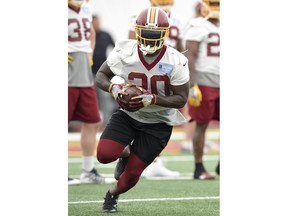 FILE - In this June 13, 2018, file photo, Washington Redskins running back Rob Kelley runs during an NFL football team practice,in Ashburn, Va. A slimmed-down Rob Kelly is likely to remain the Washington Redskins running back even though even though some big names could be joining the team to bolster its decimated backfield. Amid four injuries in their backfield, the Redskins are talking with Adrian Peterson, Jamaal Charles and former Giants running back Orleans Darkwa and could sign one or two of them. But Kelley, the former "Fat Rob" who lost weight and added speed to his repertoire, is still the front-runner to start Week 1 at the Arizona Cardinals.