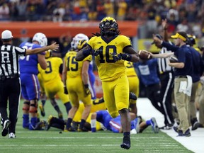 FILE - In this Saturday, Sept. 2, 2017, file photo, Michigan linebacker Devin Bush (10) celebrates a Florida turnover during an NCAA college football game, in Arlington, Texas. Bush was selected to the AP Preseason All-America team, Tuesday, Aug. 21, 2018.