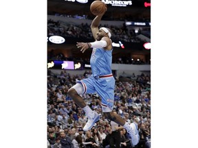 FILE - In this Feb. 13, 2018, file photo, then-Sacramento Kings guard Vince Carter (15) goes up for a dunk on a break away play in the first half of an NBA basketball game against the Dallas Mavericks, in Dallas. Carter, the oldest active player in the NBA, is about to begin his 21st season and first with the Atlanta Hawks, a rebuilding team that's likely to be among the worst in the league.
