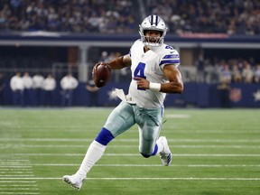 FILE - In this Aug. 18, 2018, file photo, Dallas Cowboys quarterback Dak Prescott (4) scrambles during the first half of a preseason NFL football game against the Cincinnati Bengals, in Arlington, Texas. Prescott dealt with the uncertainty of running back Ezekiel Elliott's looming six-game suspension last year when the Dallas Cowboys slid from an NFC-best 13 wins to out of the playoffs. Now the star quarterback faces the unknown of a revamped and largely unproven group of receivers after the departures of Jason Witten and Dez Bryant. Elliott, Prescott's fellow rookie standout from two years ago, is the supposed sure thing for a team looking up in the NFC East at defending Super Bowl champ Philadelphia.