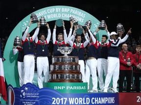 FILE - In this Nov. 26, 2017, file photo, members of the French team lift up their trophies after France won the Davis Cup final at the Pierre Mauroy stadium in Lille, northern France. The Davis Cup will be decided with a season-ending, 18-team tournament beginning next year. The new format replaces the one in which the Davis Cup is played over four weekends throughout the year.