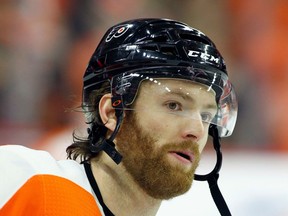 FILE - This is an April 22, 2018, file photo showing Philadelphia Flyers' Sean Couturier during warm-ups before the start of an NHL hockey game in Philadelphia. Couturier is out four weeks after suffering a knee injury for the second time in five months.  General manager Ron Hextall provided the update Wednesday, Aug. 22, 2018, saying Couturier was injured Aug. 10 in an exhibition game.