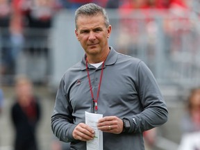 FILE - In this April 14, 2018, file photo, Ohio Setate coach Urban Meyer watches the NCAA college football team's spring game in Columbus, Ohio. Ohio State has placed Meyer on paid administrative leave while it investigates claims that his wife knew about allegations of abuse against an assistant coach years before he was fired last week.