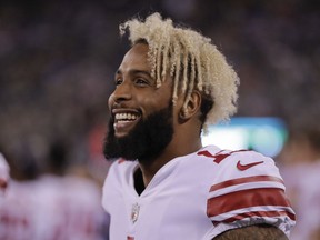 FILE - In this Aug. 24, 2018, file photo, New York Giants wide receiver Odell Beckham Jr. (13) watches from the sidelines during the fourth quarter of a preseason NFL football game against the New York Jets, in East Rutherford, N.J. Beckham Jr. is now the NFL's highest-paid wide receiver. A person familiar with the negotiations told The Associated Press Monday, Aug. 27, 2018, the team agreed to a five-year contract extension with the three-time Pro Bowler. The person spoke on condition of anonymity because the Giants have not announced the deal, which comes less than two weeks before the season opener against Jacksonville.