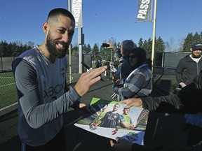 FILE - In this Dec. 6, 2017, file photo, Seattle Sounders forward Clint Dempsey signs autographs following a training session in Tukwila, Wash. Former U.S. national team captain and Seattle Sounders striker Clint Dempsey has announced his retirement, effective immediately. In a statement issued Wednesday, Aug. 29, 2018, by the Sounders, the 35-year-old Dempsey said he believes it's the right time to step away from the game.