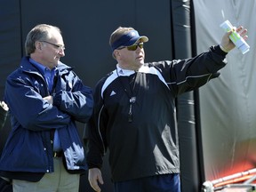 FILE - In this March 26, 2010, file photo, Notre Dame athletic director Jack Swarbrick, left, talks with head football coach Brian Kelly during his first NCAA college football practice in South Bend, Ind. Notre Dame coach Brian Kelly and athletic director Jack Swarbrick begin their ninth season together, leading the most scrutinized program in college football, when the 12th-ranked Fighting Irish face No. 14 Michigan on Saturday night, Sept. 1, 2018 . Only four Power Five schools have had the same combination of football coach and AD longer than Notre Dame.