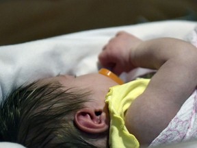 FILE - In this Feb. 13, 2018 file photo, a week-old baby lies in a neonatal intensive care unit bay at the Norton Children's Hospital in Louisville, Ky. This particular NICU is dedicated to newborns of opioid addicted mothers, that are suffering with newborn abstinence syndrome. The area is kept dark and quiet due to increased production of neurotransmitters in newborns of addicted mothers, which can disrupt the nervous system and overstimulate bodily functions. A study in Tennessee released on Thursday, Aug 30, 2018, found learning disabilities and other special education needs are more common in young children who were born with symptoms from their mothers' prenatal opioid use.