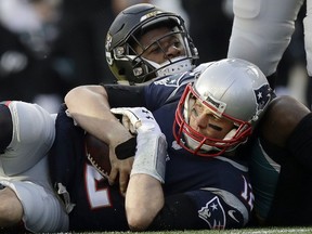 FILE - In this Jan. 21, 2018, file photo, New England Patriots quarterback Tom Brady, front, holds onto the ball as he goes down against Jacksonville Jaguars defensive end Dante Fowler during the first half of the AFC championship NFL football game in Foxborough, Mass. The Jaguars have suspended All-Pro cornerback Jalen Ramsey and Fowler for violating team rules and conduct unbecoming a Jaguars football player.