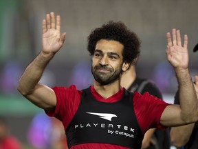 FILE - In this June 9, 2018, file photo, Egyptian national team soccer player and Liverpool's star striker Mohamed Salah smiles as he greets fans during the final training of the national team at Cairo Stadium in Cairo, Egypt. Salah has revived a months-long dispute with soccer authorities in his native Egypt, accusing them of ignoring his complaints about their unauthorized use of his image.