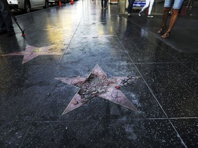 FILE - This July 25, 2018, file photo shows Donald Trump's vandalized star on the Hollywood Walk of Fame in Los Angeles. The West Hollywood City Council has unanimously approved a resolution seeking to remove President Donald Trump's star from the Hollywood Walk of Fame. The resolution urges the Hollywood Chamber of Commerce and Los Angeles to remove the star because of what it says is Trump's "disturbing treatment of women and other actions."