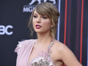FILE - In this May 20, 2018, file photo, Taylor Swift arrives at the Billboard Music Awards at the MGM Grand Garden Arena in Las Vegas. Swift honored Aretha Franklin with a moment of silence during a concert in the Queen of Soul's hometown. Swift told a sold-out crowd at Detroit's Ford Field on Tuesday, Aug. 28, Franklin did so much for music, women's rights and civil rights. Swift said words could never describe how many things Franklin did that made the world a better place.