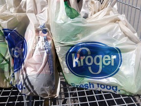 FILE - This June 15, 2017, file photo shows bagged purchases from the Kroger grocery store in Flowood, Miss. The nation's largest grocery chain will phase out the use of plastic bags in its stores by 2025.