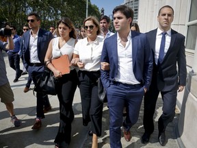 The family of Juan Angel Napout, a former top South American FIFA  soccer official, including his wife Karin Forster, center, leaves federal court following Napout's sentencing, Wednesday Aug. 29, 2018, in the Brooklyn borough of New York. Napout, of Paraguay was sentenced to nine years in prison in the sprawling FIFA bribery scandal.