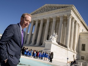 FILE- In this Feb. 27, 2018, file photo Microsoft President and Chief Legal Officer Brad Smith, left, leaves the Supreme Court in Washington. Microsoft stands virtually alone among tech companies with its aggressive approach that uses U.S. courts to fight computer fraud and seize hacked websites back from malicious perpetrators. "What we're seeing in the last couple of months appears to be an uptick in activity," said Smith.