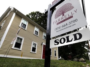 In this Tuesday, Aug. 21, 2018 photo, a home has a sold sign in North Reading, Mass. On Wednesday, Aug. 22, the National Association of Realtors reports on sales of existing homes in July.