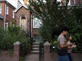 People pass by the residence of Nazi war crimes suspect Jakiw Palij on Tuesday, Aug. 21, 2018, in the Queens borough of New York. Palij, the last Nazi war crimes suspect facing deportation from the U.S., was taken from his home and spirited early Tuesday morning to Germany, the White House said.