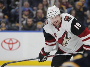 FILE - In this March 2, 2017, file photo, Arizona Coyotes forward Shane Doan (19) looks on during the first period of an NHL hockey game against the Buffalo Sabres in Buffalo, N.Y. The Coyotes will retire Doan's No. 19 during a pregame ceremony on Feb. 24, 2019, when they face the Winnipeg Jets. Doan spent his entire 21-year career with the Coyotes before retiring prior to the 2017-18 season.