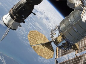 In this June 24, 2018 photo released by NASA, the Russian Soyuz MS-09 crew craft, left, and the Northrop Grumman (formerly Orbital ATK) Cygnus space freighter are attached to the International Space Station. NASA and Russian space officials stressed Thursday, Aug. 30, 2018, that the six astronauts are in no danger after a small air leak developed in one, at left, of the two Soyuz capsules docked at the space station. Russian officials say the leak was detected Wednesday night and may be the result of a micrometeorite impact. Both the crew and ground controllers are working hard to isolate the leak. (NASA via AP)