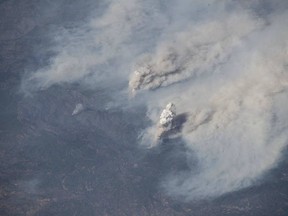 This image provided by NASA shows the California wildfires captured from the International Space Station on Aug. 3, 2018 by European Space Agency astronaut Alexander Gerst.  Northern California is grappling with the largest wildfire in California history, breaking a record set only months earlier. Experts say this may become the new normal as climate change coupled with the expansion of homes into undeveloped areas creates more intense and devastating blazes.  (Alexander Gerst/NASA via AP)