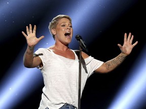 FILE - In this Jan. 28, 2018, file photo, Pink performs "Wild Hearts Can't Be Broken" at the 60th annual Grammy Awards at Madison Square Garden in New York.  Pink was admitted to a Sydney hospital on Monday, Aug. 6, with a virus, forcing her to postpone a second show, her promoter said. The singer's "Beautiful Trauma" world tour's first concert in Sydney was scheduled for last Friday, but she canceled that show on doctor's orders. She battled through a Saturday night show.